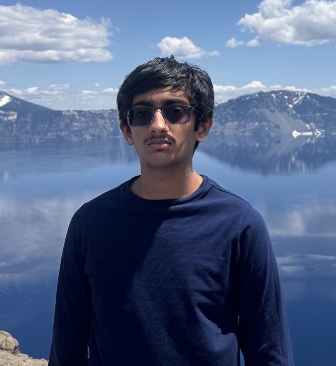 Kshitij Biradar, founder of PrepFriend, in front of a mountain lake